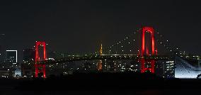 Rainbow Bridge lit up in red